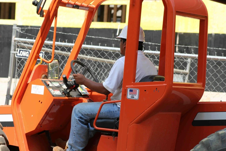 the driver of a forklift truck is operating the control on