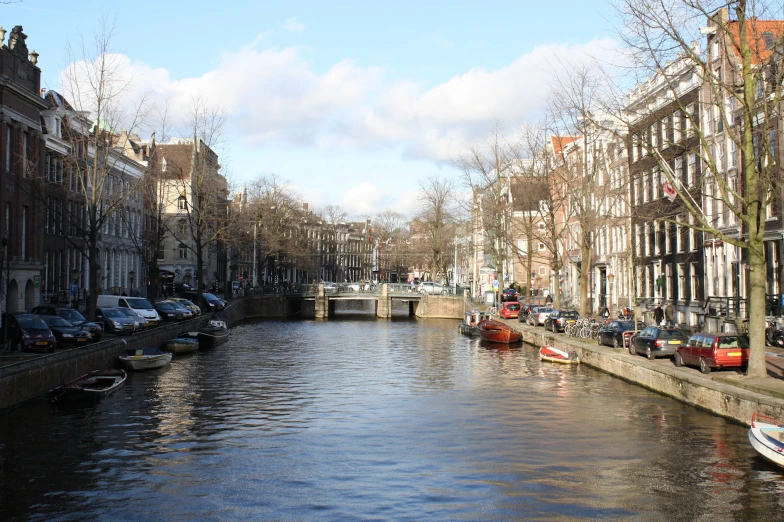 the canal on the side of the road is calm