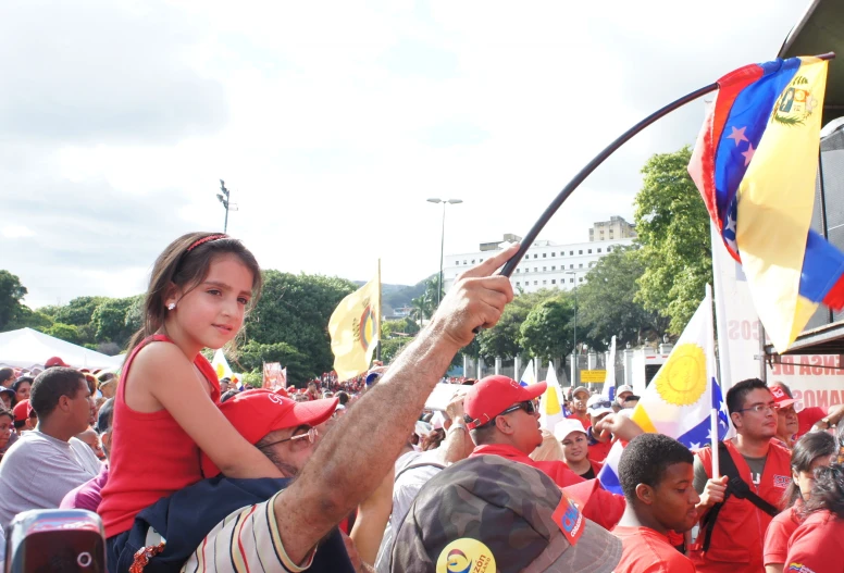 a group of people with flags in the back