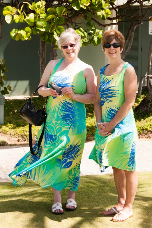 two women in bright dresses standing next to each other