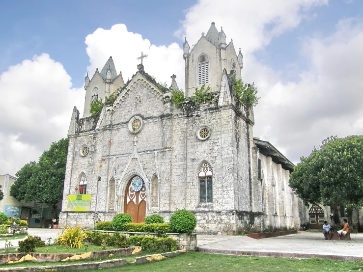 an old stone church that has a clock on the outside