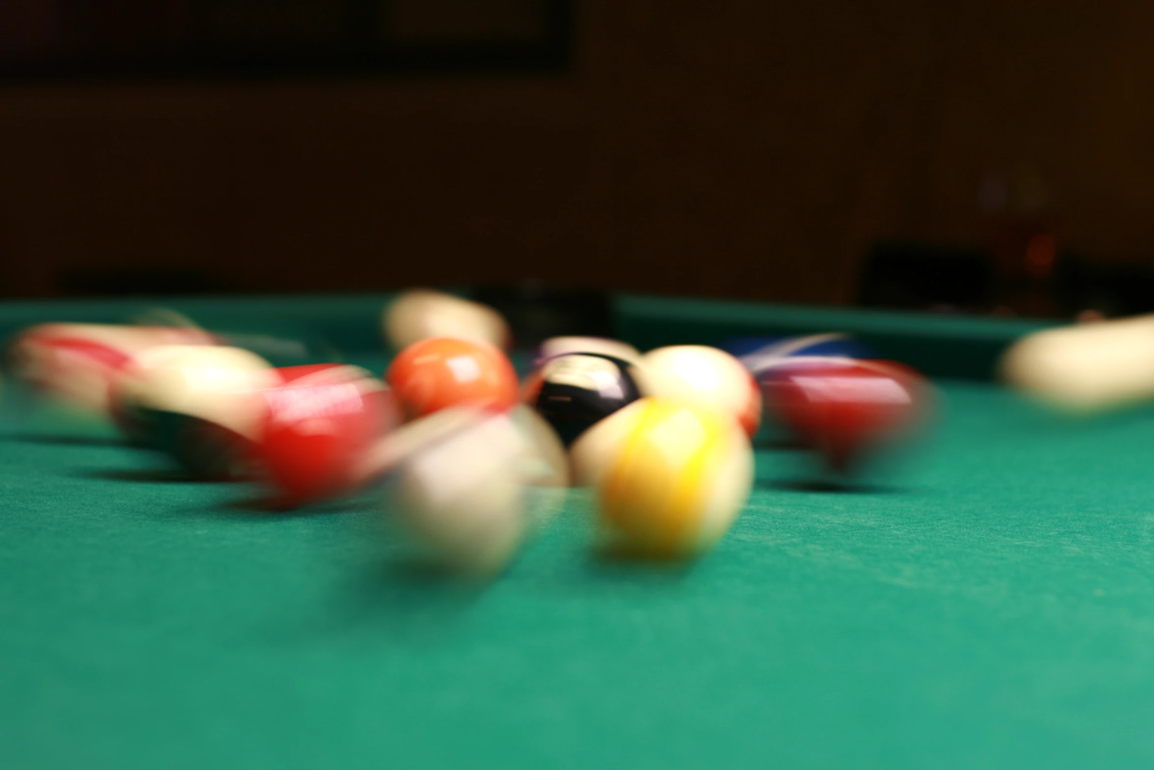 pool balls and cues lying on top of a pool table