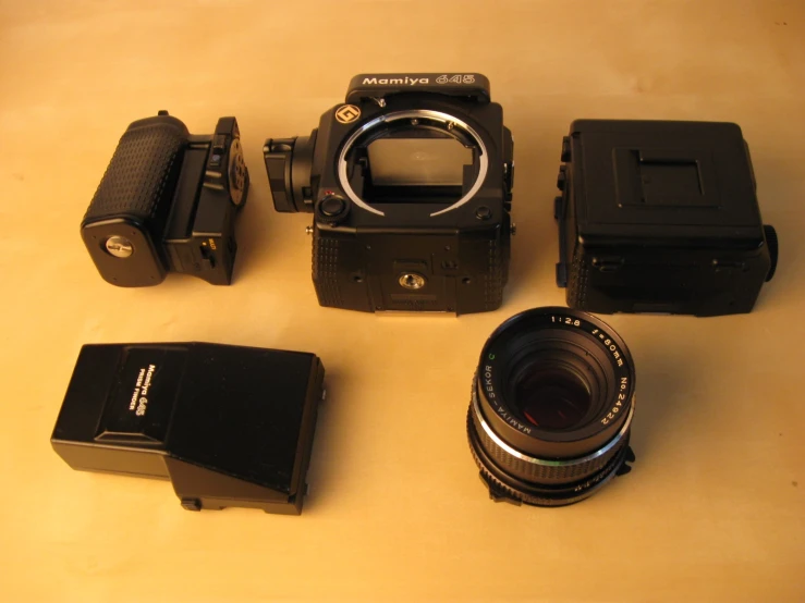 a small camera and other gear placed on a table