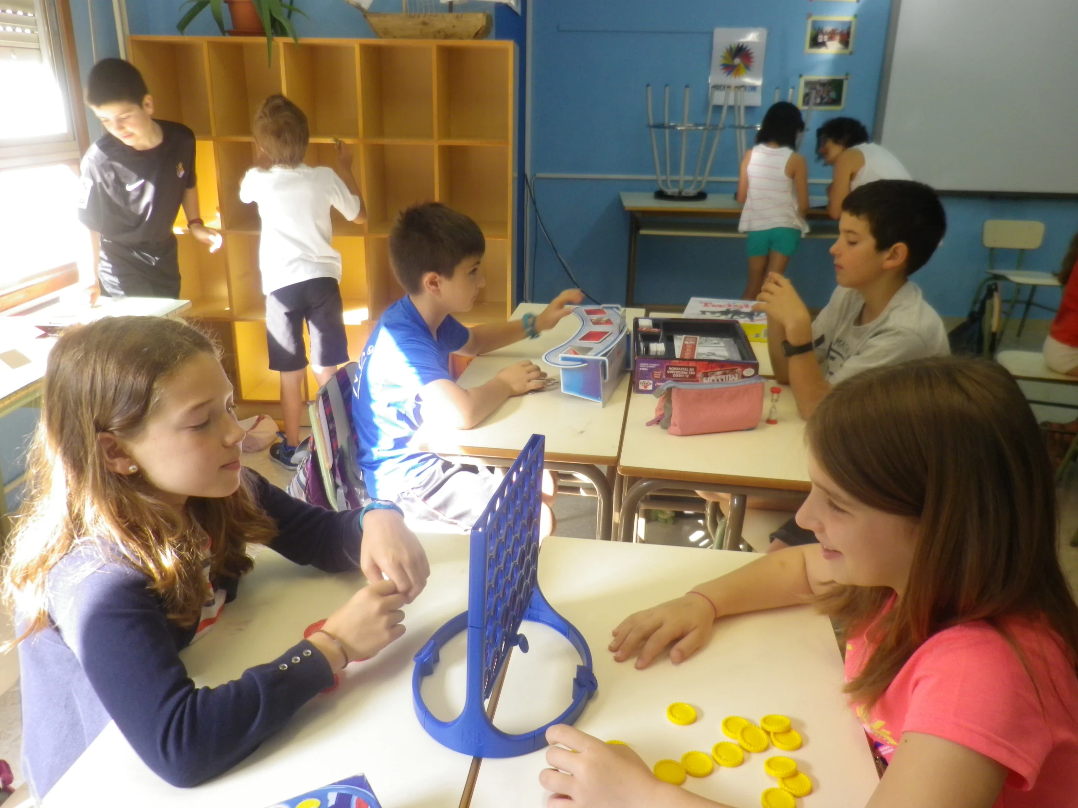 the children are at the table playing with plastic objects