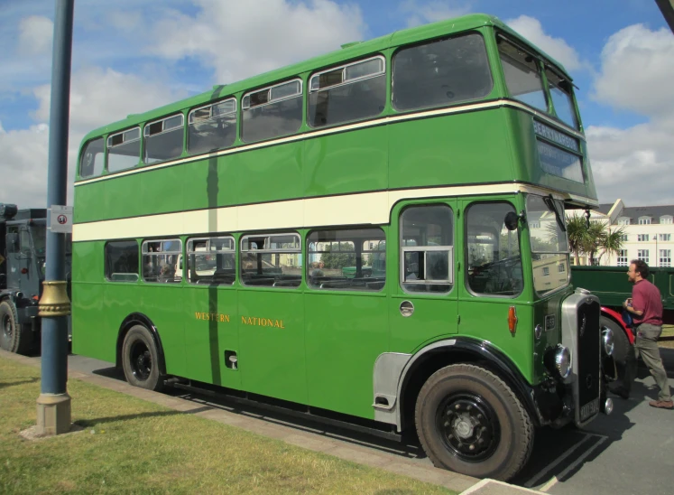 green bus parked on the side of a road