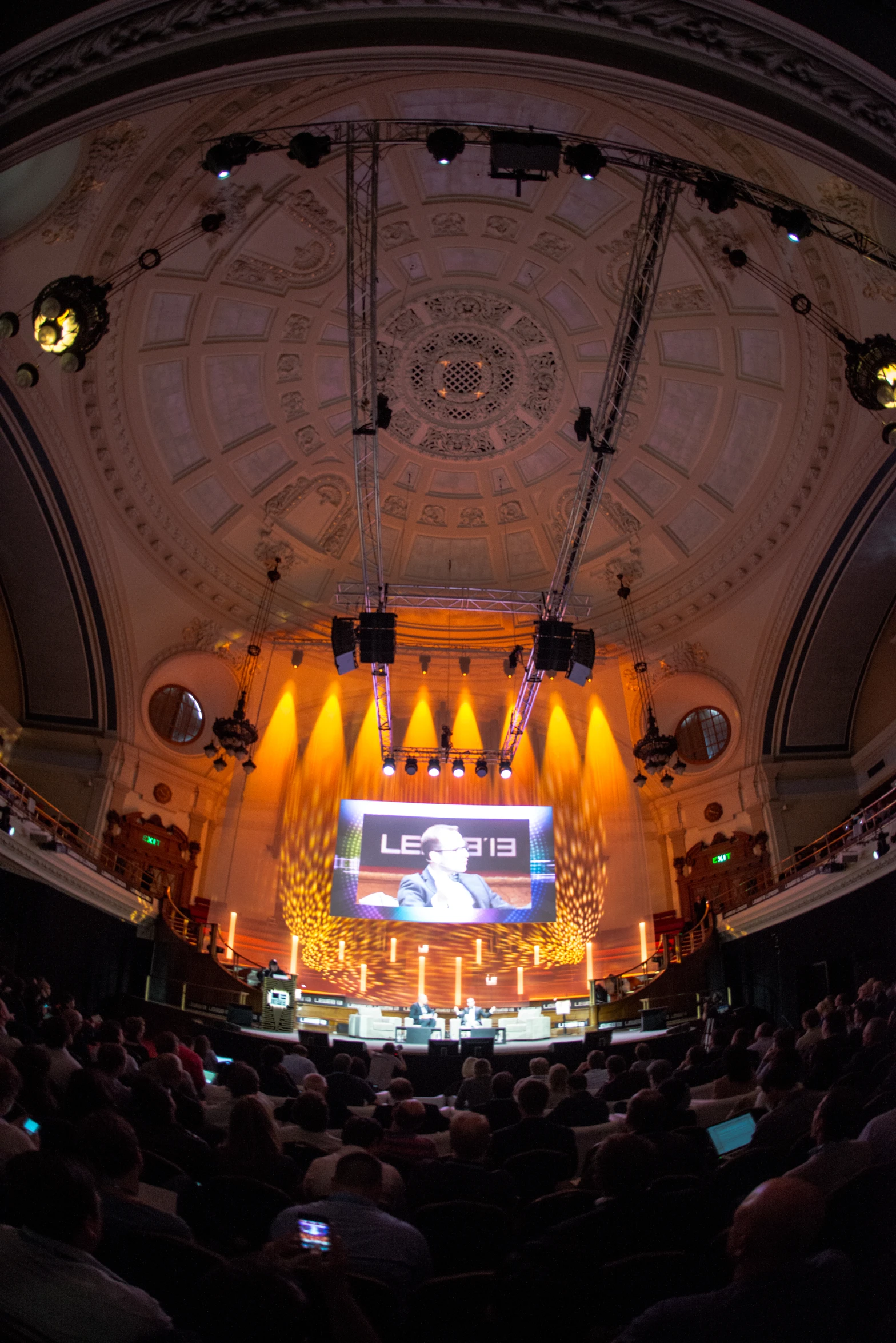 an auditorium filled with people and lights during a performance