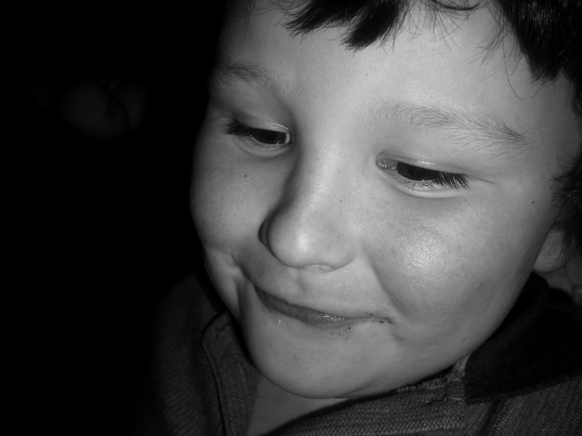 man lying down in black and white with dark background