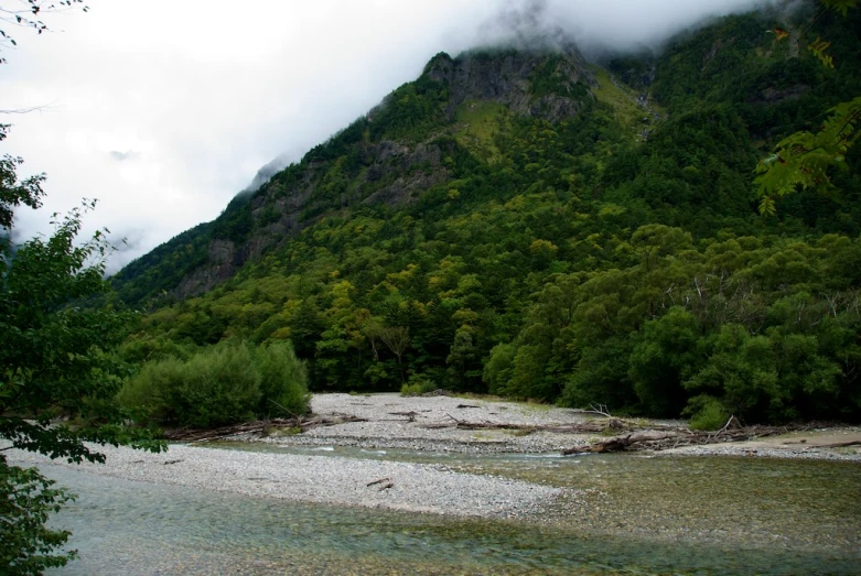 a body of water that has a hill in the back