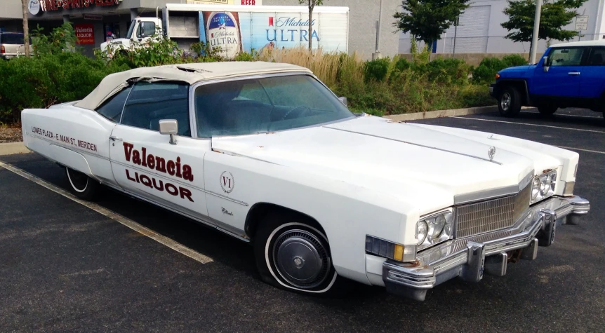 an old police car sitting in a parking space