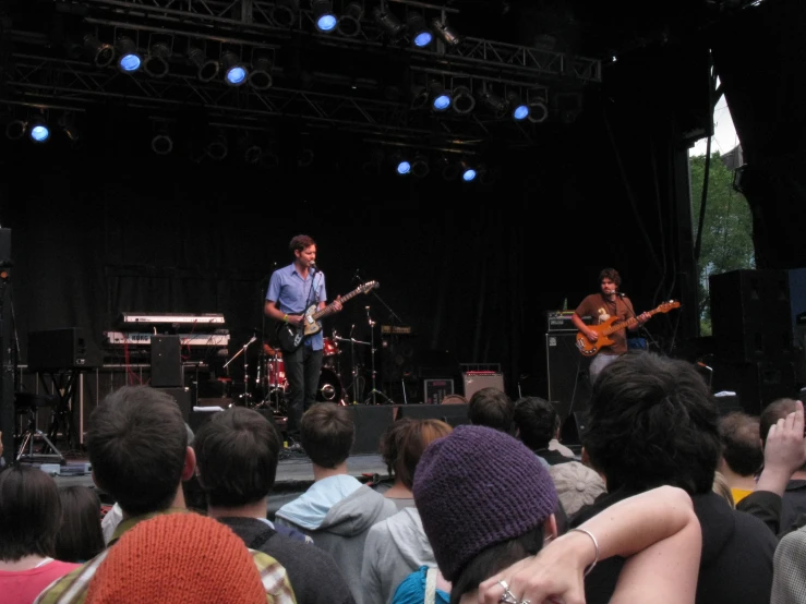 a band playing on stage and some people watching