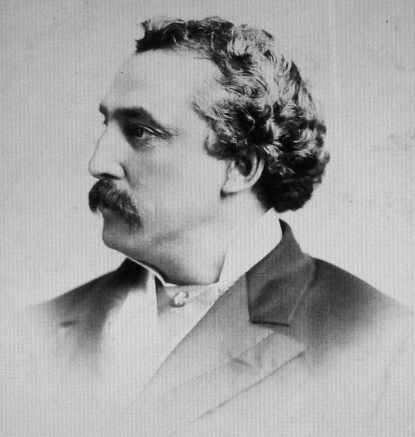 a picture of a man with curly hair and a mustache