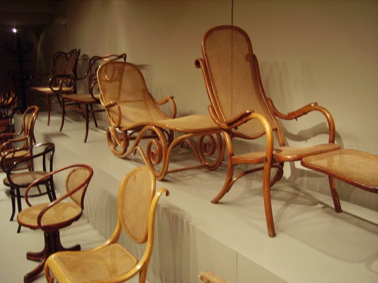 an assortment of chairs and benches are arranged in a row