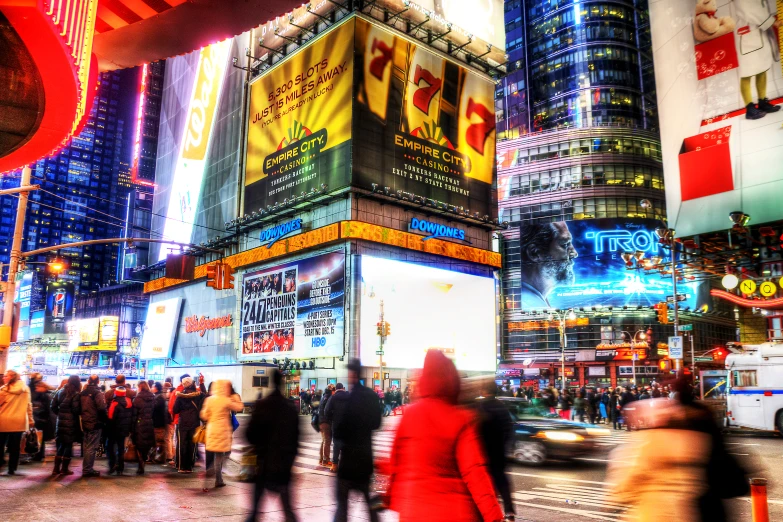 people are walking around in the city at night