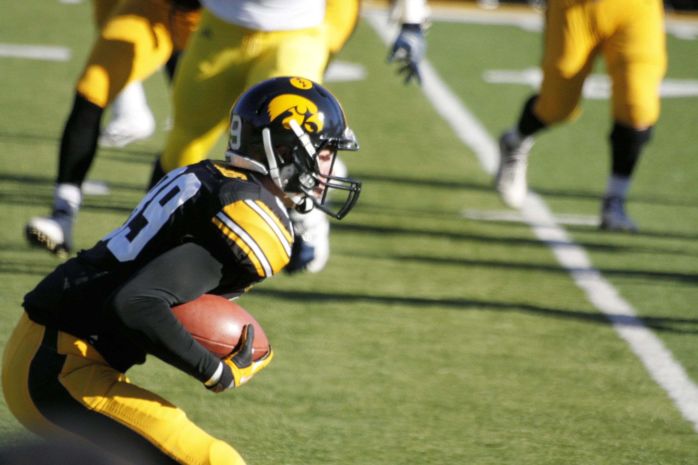 a football player is running with the ball