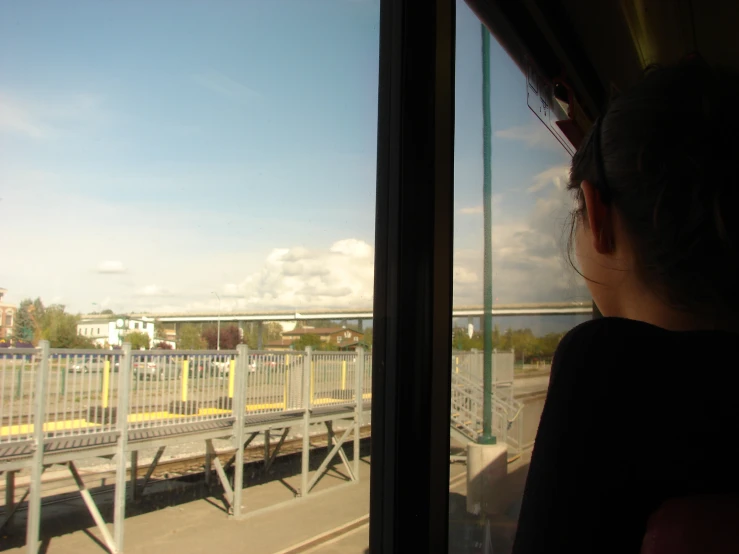 a view from inside a passenger train looking at a bridge