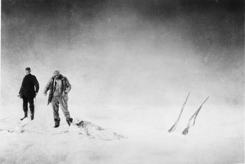 a couple of people walking in the snow together