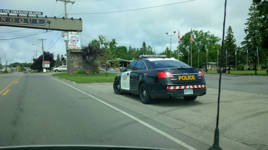 the police car is parked in front of the building