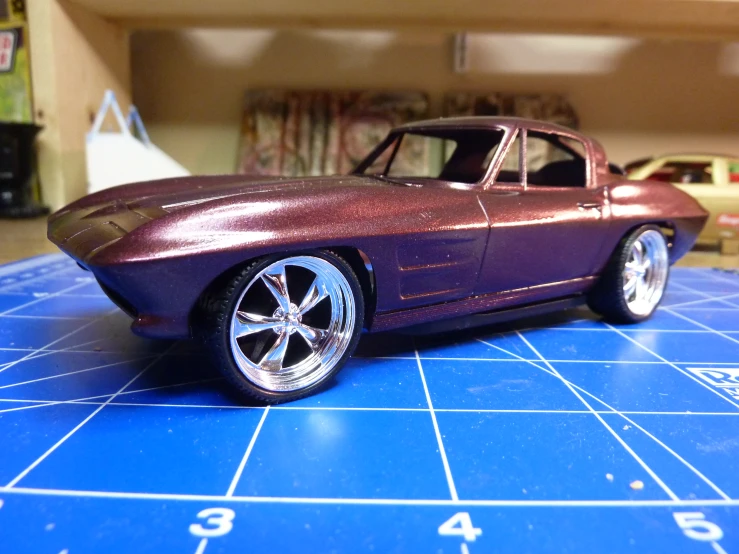 a toy model car sitting on a blue counter