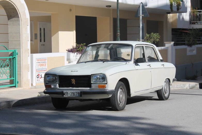 a white station wagon sits on a street corner