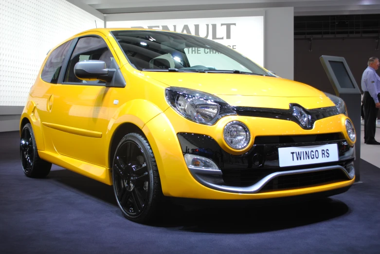 a yellow car parked in front of a sign with an advertit