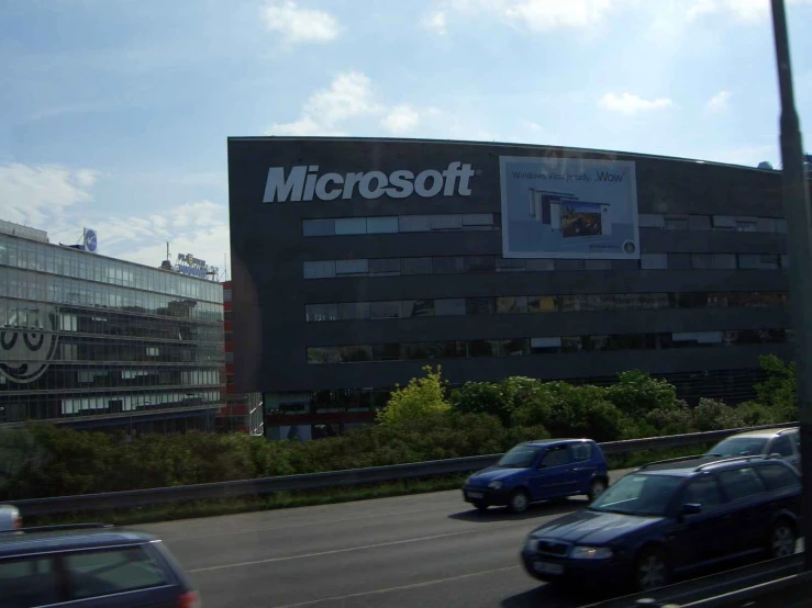 a building with microsoft windows that is near by cars