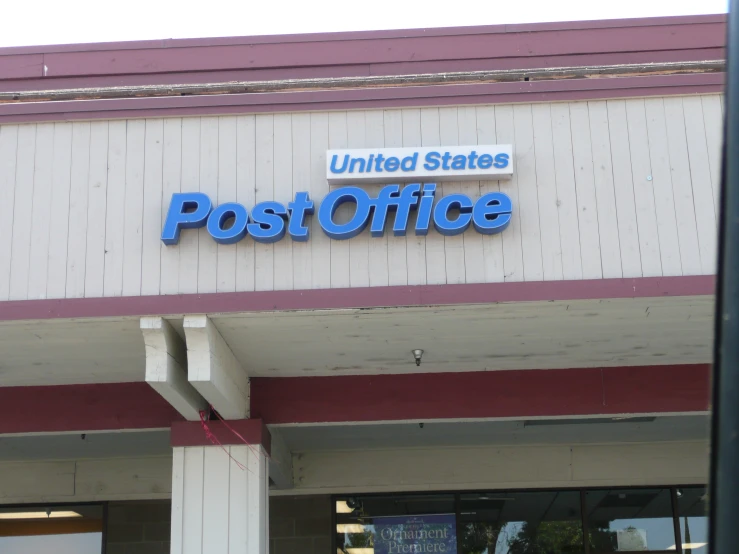 a post office building sign on the side