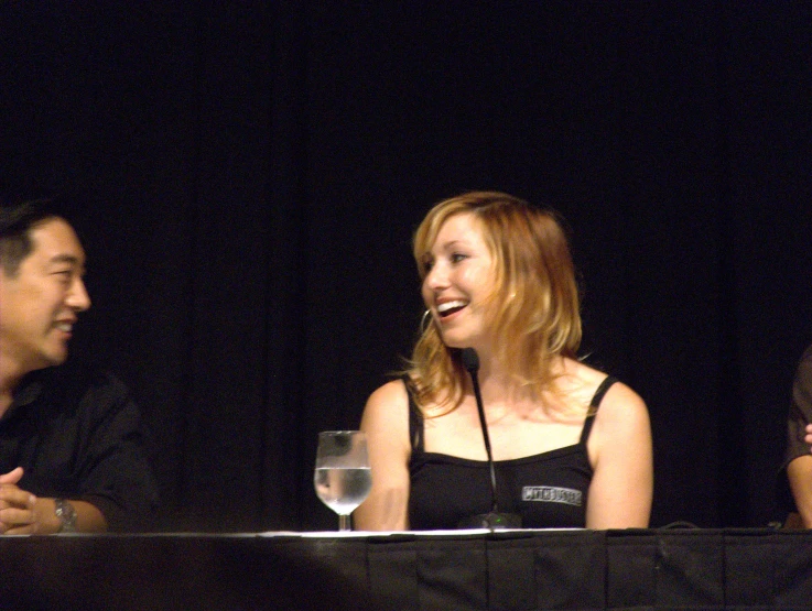 three people at an event sitting at a table