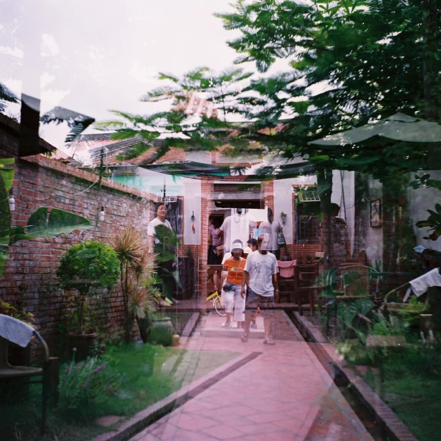 two people are standing on a red tile walkway