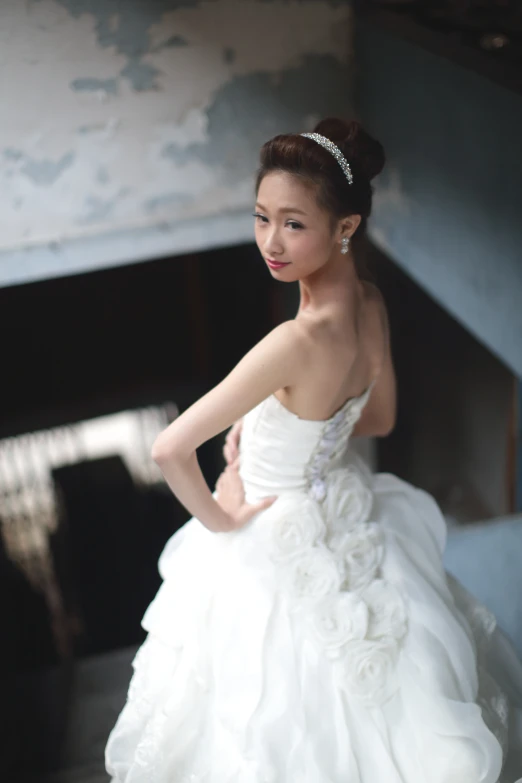 young asian bride wearing a white dress and high ponytail
