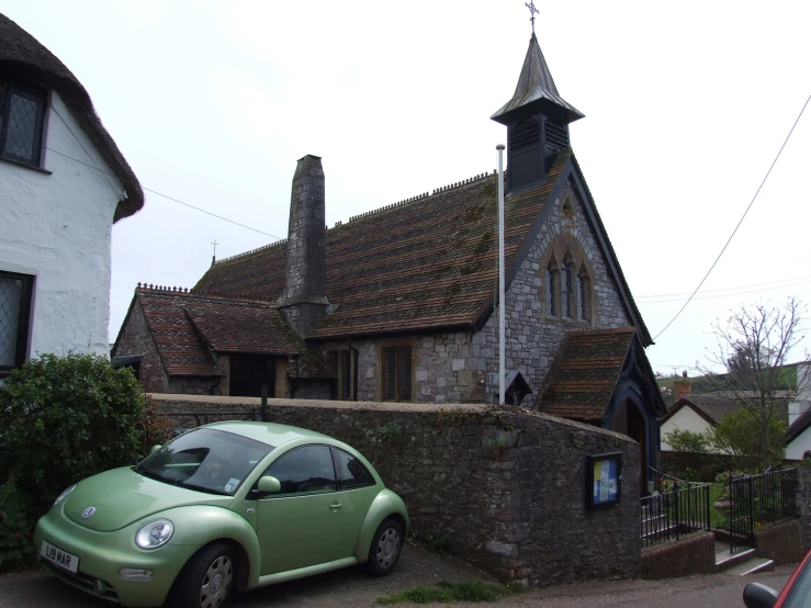 the car is parked next to a church