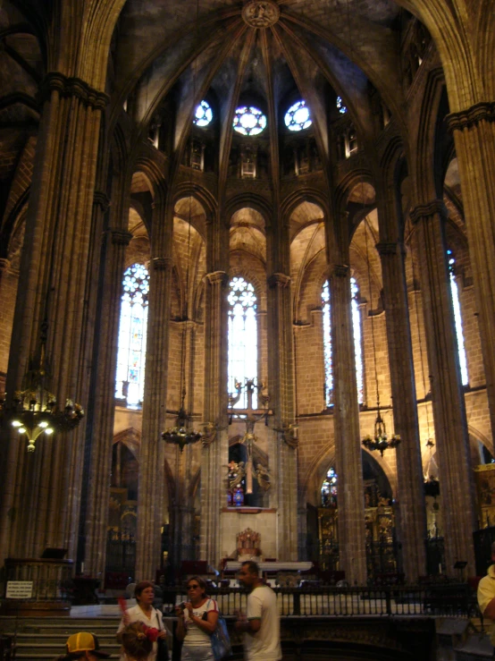 three men are standing in front of a large gothic church