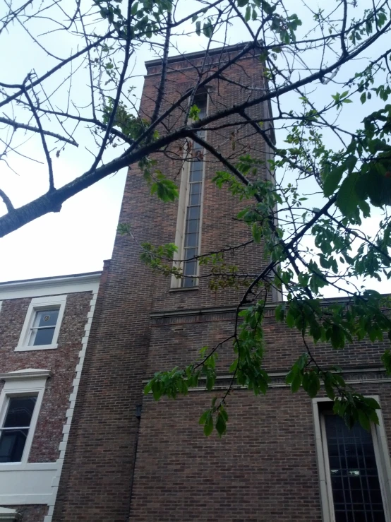 a brick building has a clock tower next to it