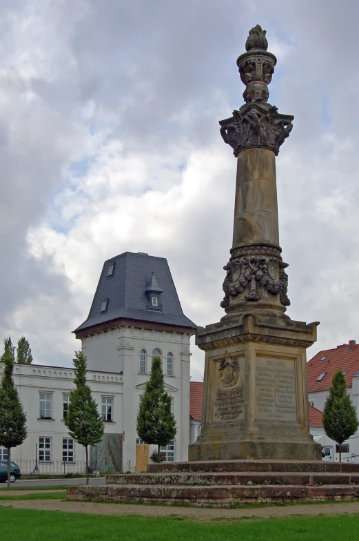 a statue stands in front of buildings