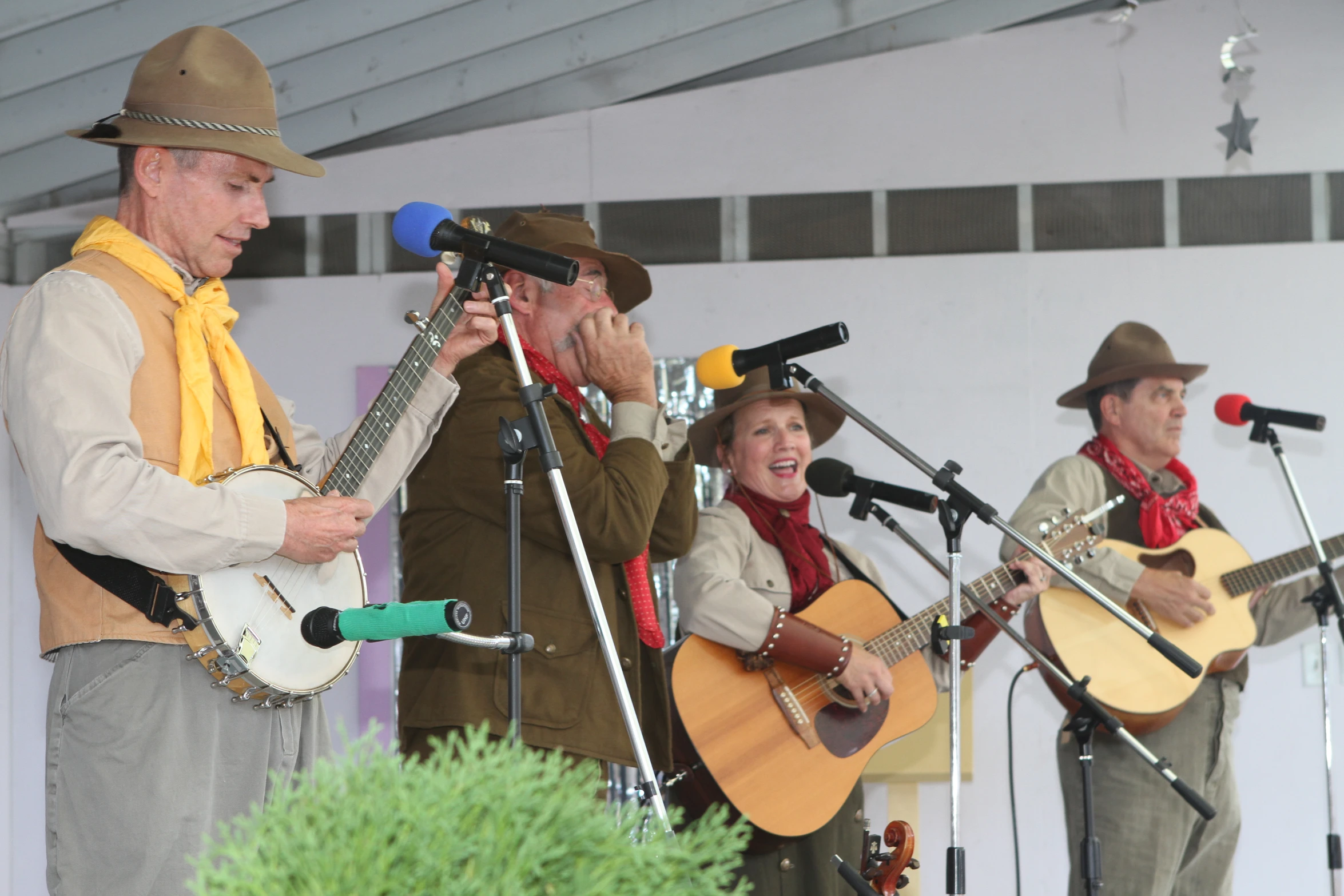 four people are playing musical instruments on stage