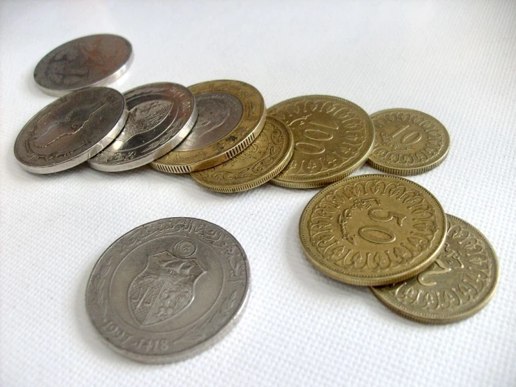 a pile of mexican gold and silver coins