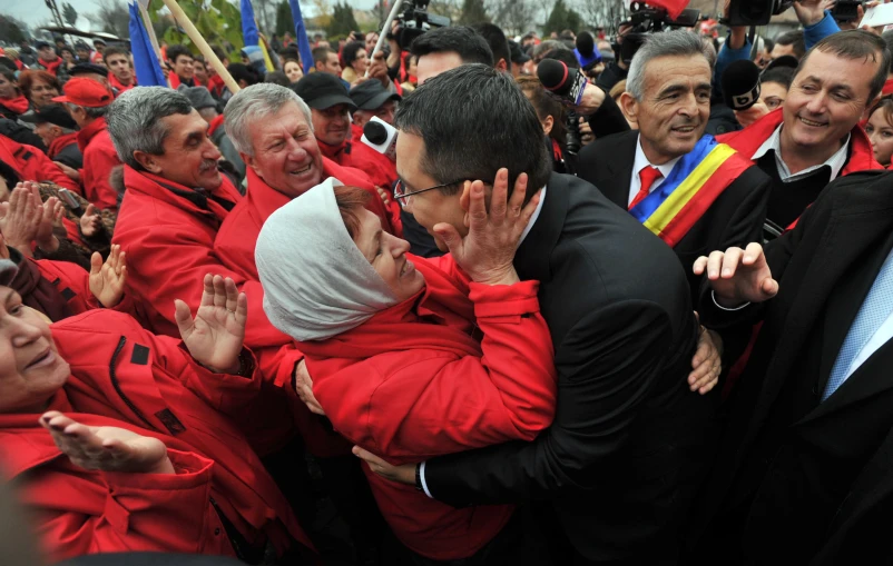 a man is emcing his head as he is surrounded by people