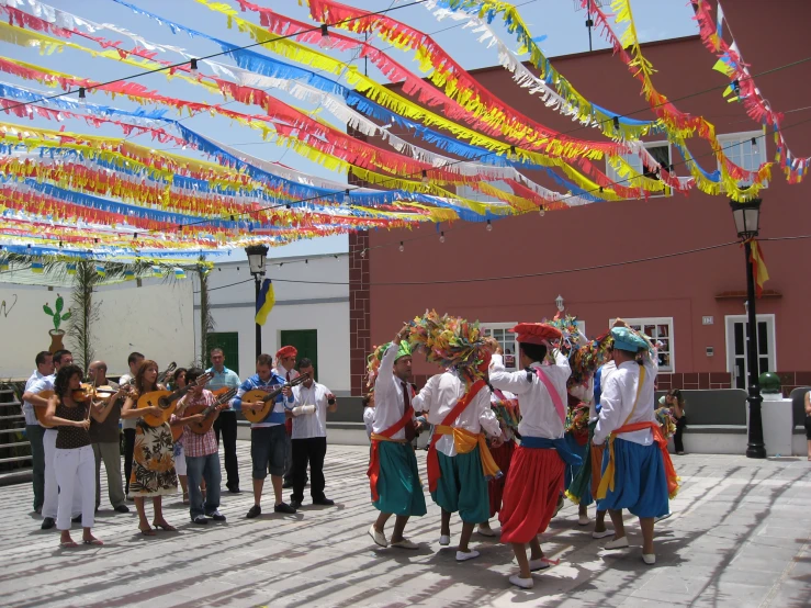 several people dressed in costume standing under some strings