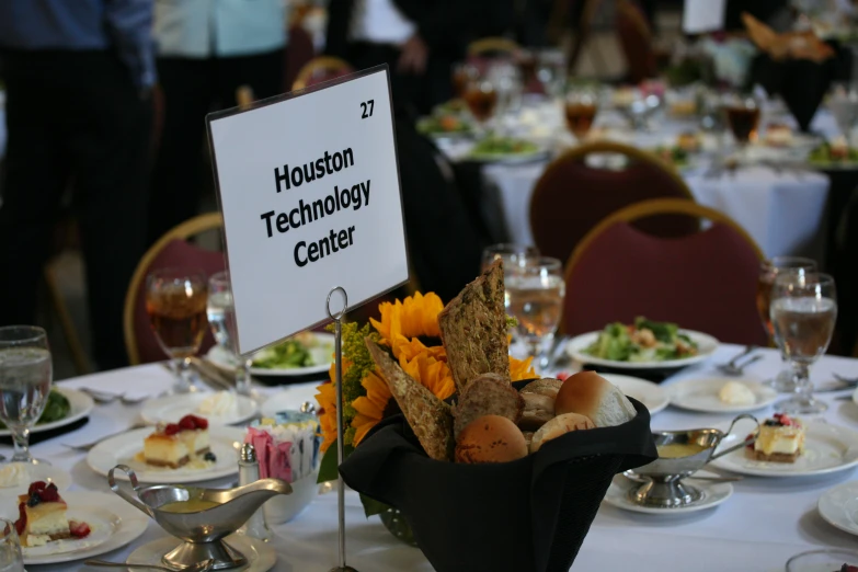 a table topped with plates and a vase filled with flowers