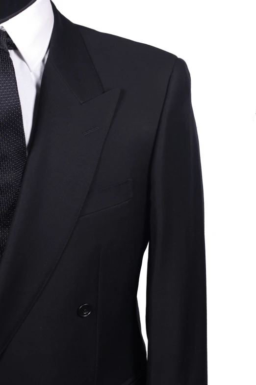 a black suit with black dots on it and tie