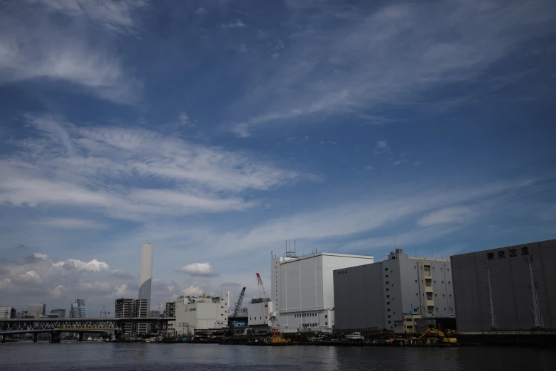 a large industrial building with some water in front of it