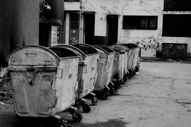 a row of trash can in an alley