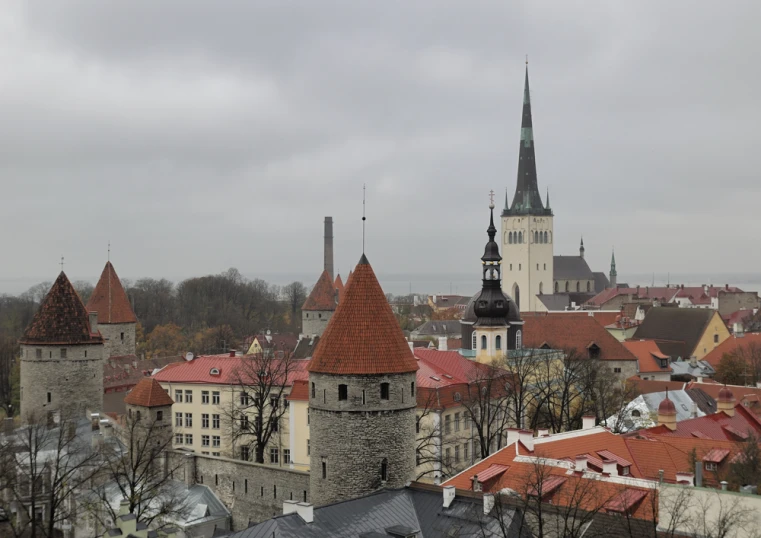 an old city with several towers with red roofs