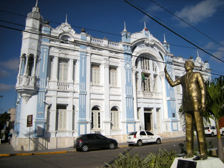 a building with blue painted walls and a gold statue