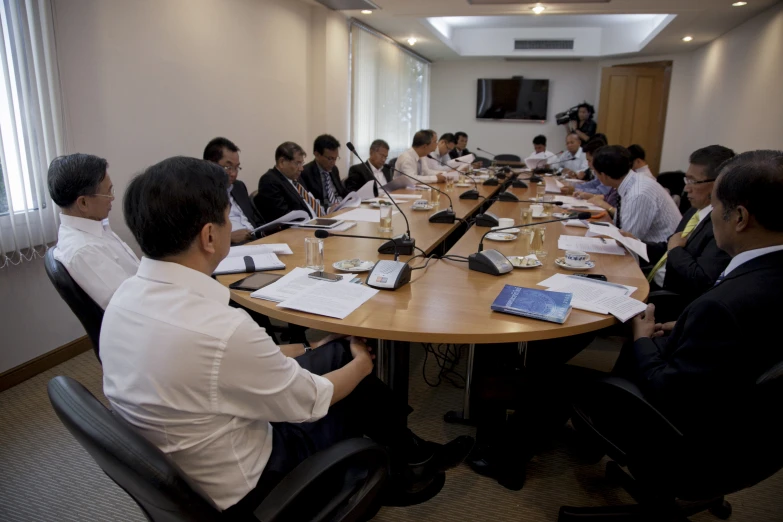 a group of business people sitting around a conference table