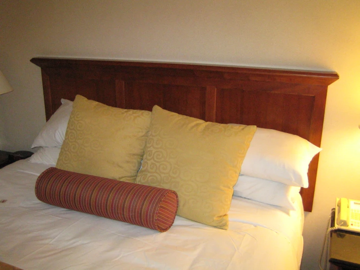 a bed with three matching pillows is neatly made