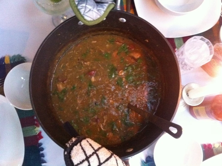 a bowl of soup on a table with other dishes