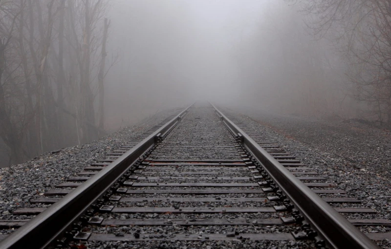 there are many train tracks on this misty day