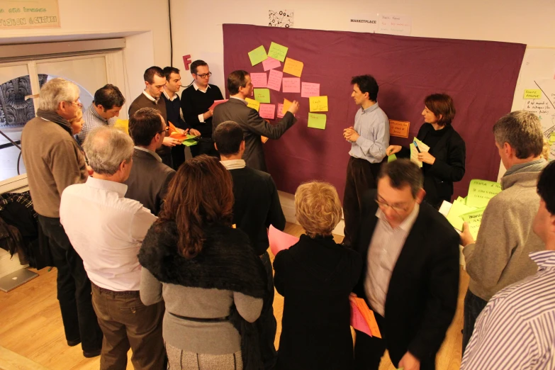 a group of people gather in an office building