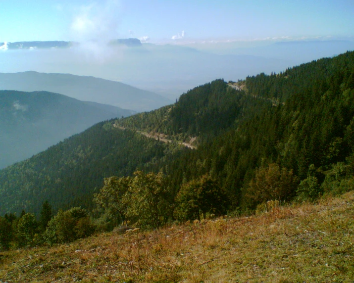 a road in the mountains as seen from a lookout