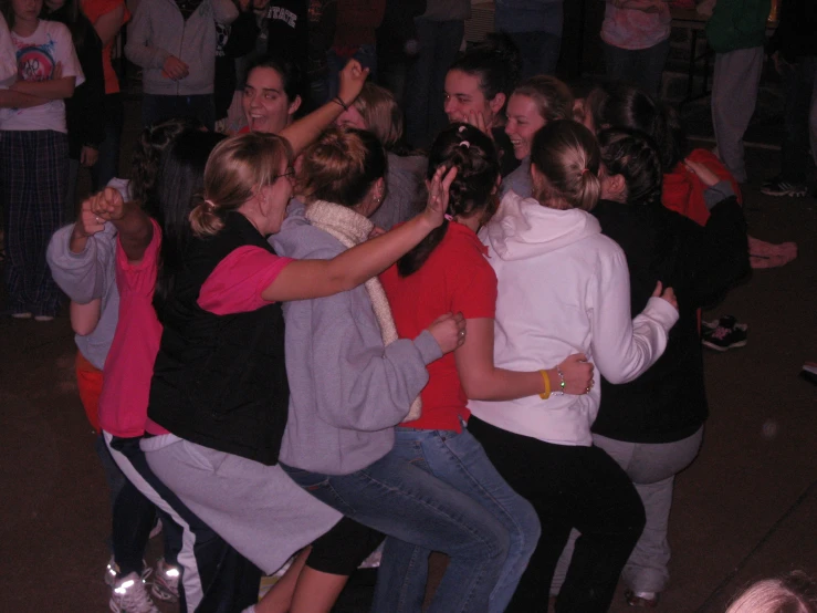 people dancing in a crowd at a party